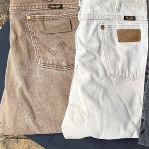 2 Wrangler Bootcut Jeans in Tan and white.